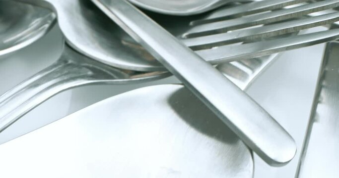extreme close-up, detailed. stainless steel spoons and forks.