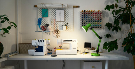 Comfortable home sewing workshop with overlock equipment and sewing machine.
