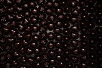 Lots of handmade chocolate candies with filling in a chocolate factory