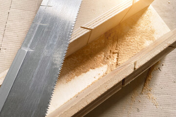 Hand saw with a shape for the correct bending angle. DIY repair at home, hand saw