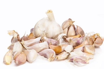 A lot of unpeeled garlic on a white background