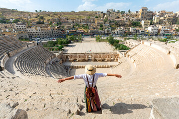 Rear view of beautiful young woman standing in front of the South Roman Theater, Amman, Jordan