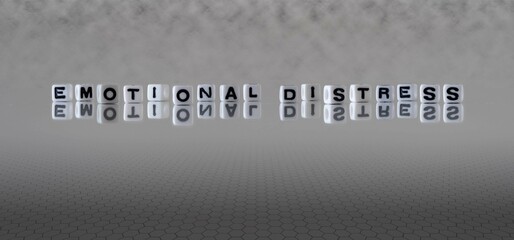 emotional distress word or concept represented by black and white letter cubes on a grey horizon...