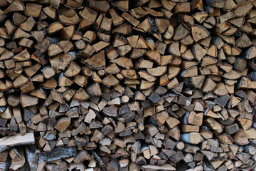 textured background of firewood from chopped wood for kindling and heating the house. woodpile with stacked firewood. birch texture. banner