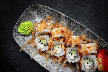 Sushi roll Bonito with eel and tuna on a dark background