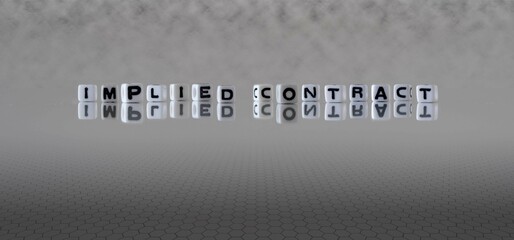 implied contract word or concept represented by black and white letter cubes on a grey horizon...