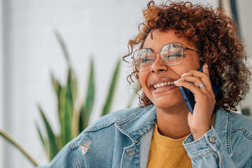 portrait of smiling african american girl talking on mobile phone