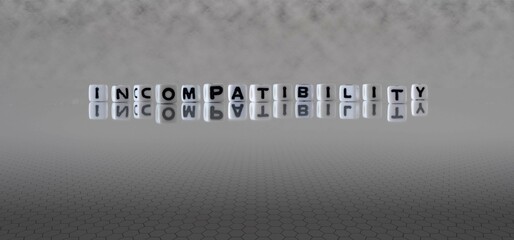 incompatibility word or concept represented by black and white letter cubes on a grey horizon...