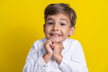Front view of small caucasian boy four years old standing in front of yellow background studio shot child making poses looking to the camera surprised or impatient copy space - obrazy, fototapety, plakaty