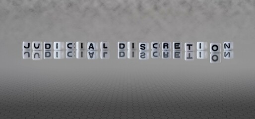 judicial discretion word or concept represented by black and white letter cubes on a grey horizon...