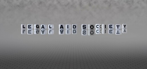 legal aid society word or concept represented by black and white letter cubes on a grey horizon background stretching to infinity