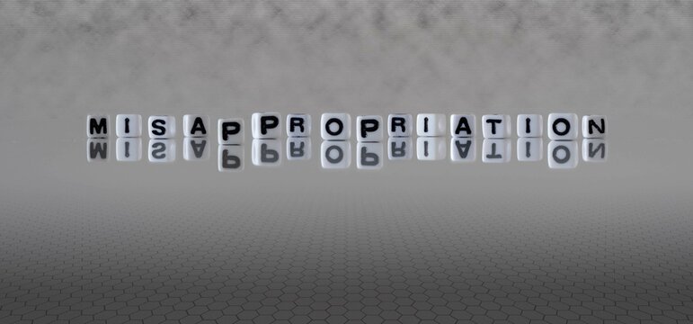 misappropriation word or concept represented by black and white letter cubes on a grey horizon background stretching to infinity