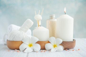 Natural relaxing spa composition on massage table in wellness center    with towels, flowers and...