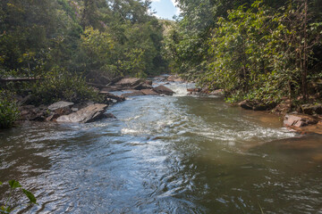 Naklejka na ściany i meble The small Itiquira River that flowing down from the Indaia waterfall near Planaltina, and Formosa, Goias, Brazil