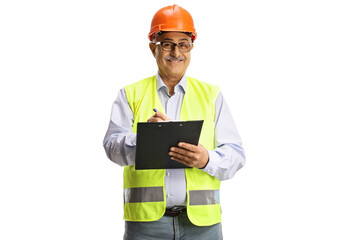 Mature male engineer with a safety vest writing a document and smiling at camera