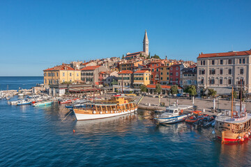 Fototapeta na wymiar ROVINJ, CROATIA - August 19th, 2021: Many boats in the harbour near olld town of Rovinj, popular travel destination in Croatia