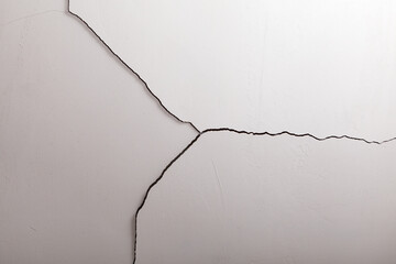 Crack in the ceiling. Surface paint and stucco are damaged. White paint, Concrete Old Wall Texture Background