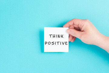 The words think positive are standing on a paper, optimistic mindset, coaching and motivation concept, attitude for success
