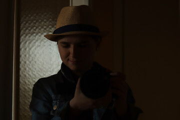 Defocus young woman take photography in mirror reflection. Millennial woman in hat. Dark black portrait. Mental health. Narcissism. Photographer. Out of focus