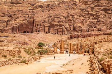 Petra main street with ancient Nabataean Royal tombs in the background and ruins of grand temple in...