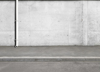 a fragment of a street city concrete wall of a building, a rain facade pipe or a rain shower on the facade and an asphalt pavement. Building's facade. Template or layout