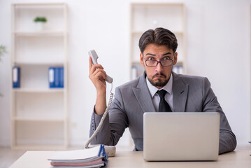 Young male employee working in the office