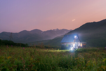 Forester's house in the mountains at night