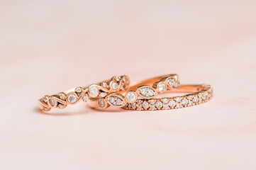 Stacked rose gold diamond ring with pink background