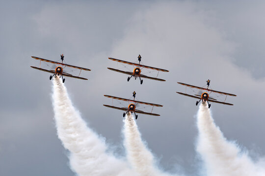 Farnborough, UK - July 20, 2014: Breitling Wing Walkers vintage Boeing Stearman Biplanes flying in formation.
