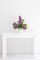 a bouquet of lilac in a white vase