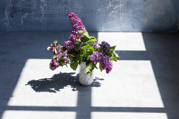 Fototapeta na wymiar lilac in vase on dark background