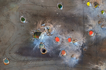 Bullet holes in cold rolled steel sheet