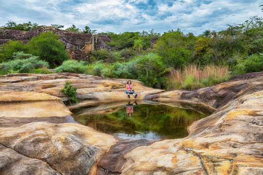 On the way to the rock arch you pass the mirror lagoon of the rocky plateau of Cerro Arco in Tobati, Paraguay.