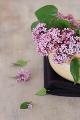 Lilac flower bouquet on brown background, spring flower bouquet, spring wallpaper, still life.