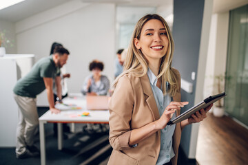 Businesswoman posing and smiling during a meeting in an office