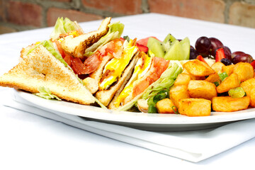 Breakfast club sandwich and assorted fruits