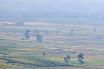 Scenario of agricultural crops in the Mantaro Valley at dawn even with fog.