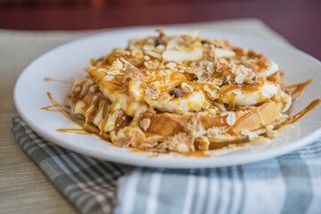 Waffle topped with apples and walnuts