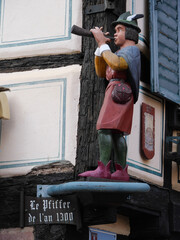 Geschnitze Holzfigur eines Pfeiffers an einem alten Fachwerkhaus in Karlsstadt (Bayern)