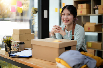 Startup small business entrepreneur SME, asian woman packing box. Portrait of young Asian small business owner in home office, online sell marketing delivery, SME e-commerce telemarketing concept