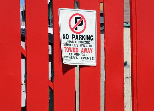 No Parking Tow Zone Area With Warning Sign On Red Wood Planks