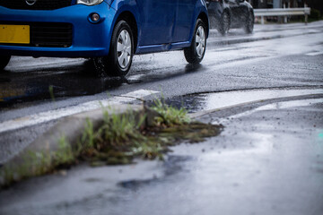 雨の道を走る車　A car running on a rainy road	