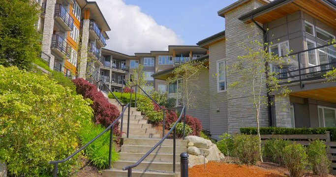 Establishing shot of modern apartment building with beautiful spring blossom landscape in Vancouver, Canada, North America. Day time on April 2022. ProRes 422 HQ.