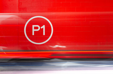 Commercial Parking Lot Level 1 Sign on Red Wall with Motion Blur