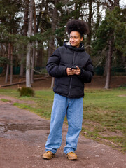 Fototapeta premium Girl using mobile phone in park