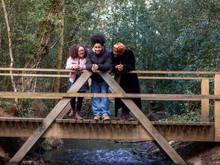 Mother with two daughters on footbridge