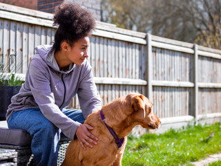 Girl with dog in backyard