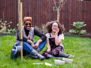 Portrait of mother and daughter in backyard