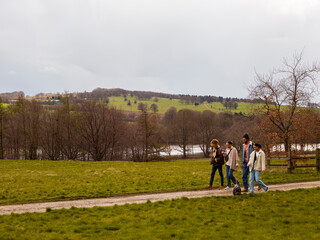 Group of young friends with dog in countryside