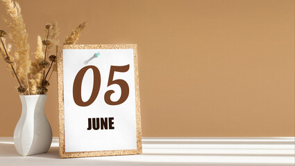 june 5. 5th day of month, calendar date.White vase with dead wood next to cork board with numbers. White-beige background with striped shadow. Concept of day of year, time planner, summer month